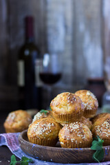 cheese muffins with sesame seeds with a glass of red wine on a dark wooden background in rustic style. holidays, summer, autumn, winter, new Year, vegetarian, celebration, healthy, Christmas, festive,