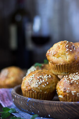 cheese muffins with sesame seeds with a glass of red wine on a dark wooden background in rustic style. holidays, summer, autumn, winter, new Year, vegetarian, celebration, healthy, Christmas, festive,
