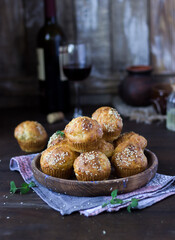 cheese muffins with sesame seeds with a glass of red wine on a dark wooden background in rustic style. holidays, summer, autumn, winter, new Year, vegetarian, celebration, healthy, Christmas, festive,