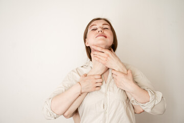 the victim of domestic violence stands on a white background, male hands are strangling, the girl...