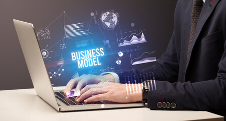 Businessman working on laptop with BUSINESS MODEL inscription, new business concept