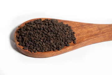 Dried Tea Leaves powder on Spoon With White Background