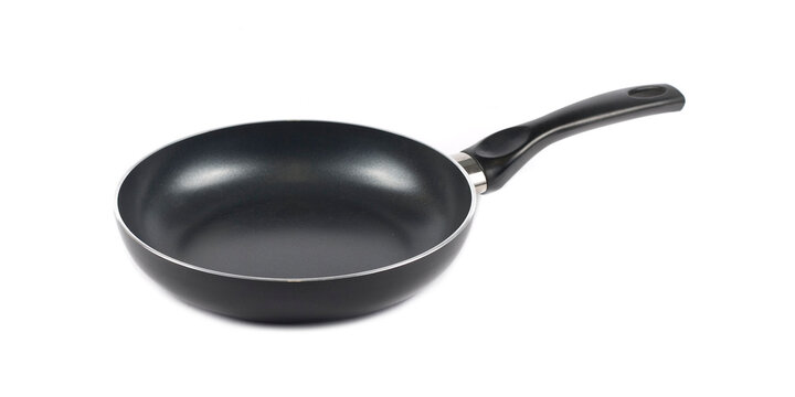 Metal black frying pan with a non stick coating composition isolated over the white background