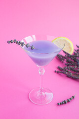 Lavender drink  with lemon in martini glasses  on the pink  background. Location vertical. Copy space.