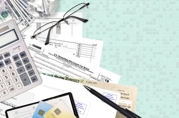 IRS form 1040NR Nonresident Alien Income tax return lies on flat lay office table and ready to...
