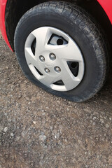 Fototapeta na wymiar Car flat tire, closeup. Car breakdown on the road. Tire service.