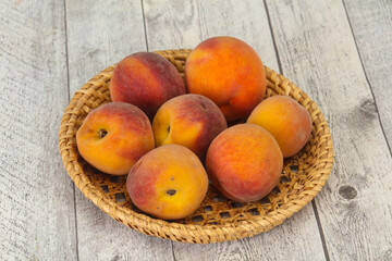 Peach heap in the wooden basket