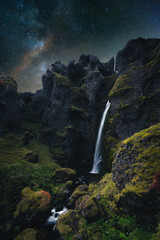Beautiful Waterfall in Iceland at Night with view of the milky way and stars
