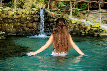 Fototapeta premium Beautiful woman in the nature pool