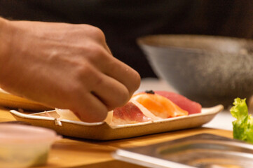 Making Japanese food with hands, raw fish sushi with fish eggs
