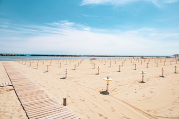 Intentionally overexposed shot of the beach of Bellaria Igea Marina, in the riviera Romagnola area on the Adriatic coast. Usually crowded, now deserted due to social distancing and sanitary emegency