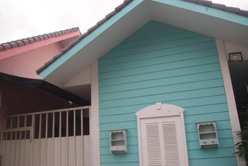 Fototapeta premium A colorful wooden house looks from the side
