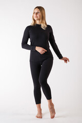 Girl in thermal underwear on a white background. Sportswear.