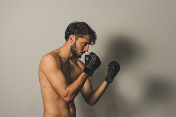 Fototapeta na wymiar portrait of a young man with boxing gloves