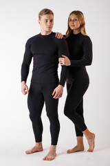 Guy and girl in thermal underwear on a white background