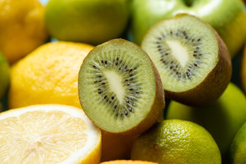 Fototapeta na wymiar close up view of kiwi halves on lemons and limes