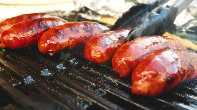 close-up view of tasty  chorizo sausages grilling on charcoal grill