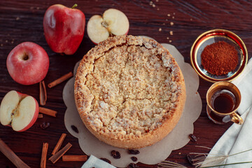 Homemade delicious apple pie with different ingredients on rustic background. Classic autumn...