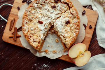 Homemade delicious apple pie with different ingredients on rustic background. Classic autumn Thanksgiving dessert - organic apple pie.
