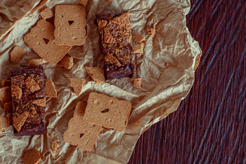 Delicious chocolate brownies with speculaas biscuits on rustic background. Chocolate dessert aesthetics