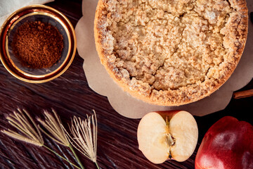 Homemade delicious apple pie with different ingredients on rustic background. Classic autumn...