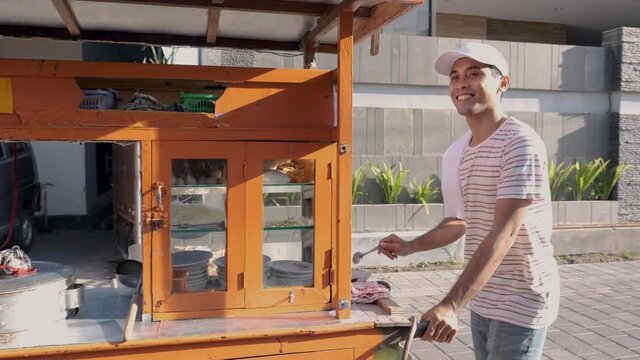 man selling bakso in the carts. indonesia street food vendor. small business entrepreneur