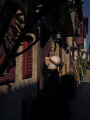 Woman standing near the stone building