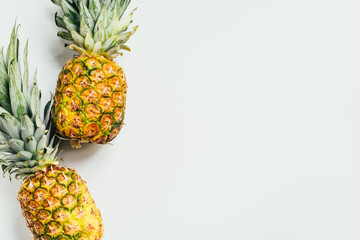 top view of fresh ripe pineapples on white background