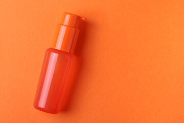 cosmetic flacon bottle on the orange