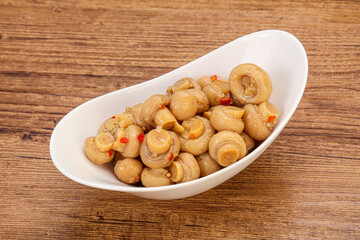 Pickled champignons in the bowl
