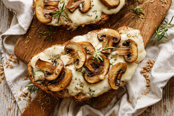 Toasted sandwich from traditional sourdough bread with cheese and brown mushrooms seasoned with...
