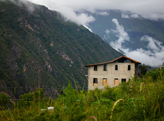 house in the hills of Cusco with fog