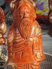 OF AN INDIAN  WOODEN ART OF A TINY STATUE OF RABINDRANATH TAGORE