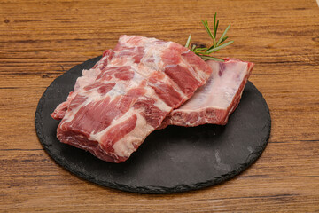 Raw pork ribs served rosemary