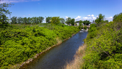 Fototapeta na wymiar Cornwall, Ontario, Canada - 2020 June 6th canal in Lamoureux Park panorama