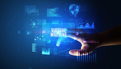 Hand touching VIRTUAL MACHINE inscription, new business technology concept