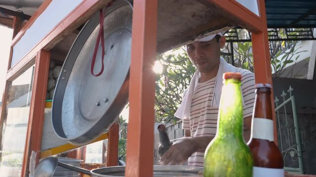 man selling bakso in the carts. indonesia street food vendor. small business entrepreneur