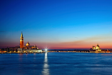 Fototapeta premium The Chiesa di San Giorgio Maggiore (left) and the Basilica di Santa Maria della Salute (right). Behind them, Giudecca isiand. View from Sestiere di Castello, Venice, Italy.