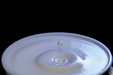Milk waves on a cup full of milk