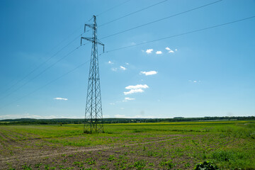 Electric pole in the field and blue sky