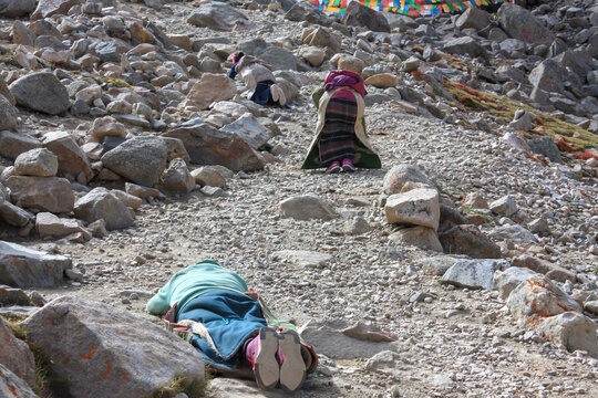 Pilgrims prostrating on stony trekking kora around mountain Kailash pilgrimage route near Darchen, Tibet, Asia