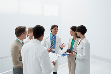 Smiling doctors discussing medical charts