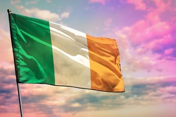 Fluttering Ireland flag on colorful cloudy sky background. Prosperity concept.