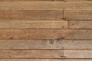 Obraz premium Close-up horizontal stripes of wood plank brown texture background with seam of wooden panels of wall.