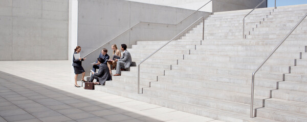 Business people meeting on concrete steps