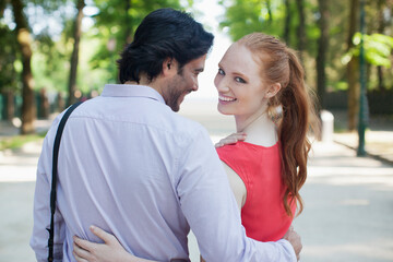 Obraz premium Portrait of smiling woman walking with boyfriend in park