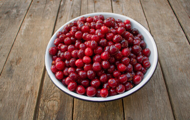 A bowl of sweet cherries on a wooden background