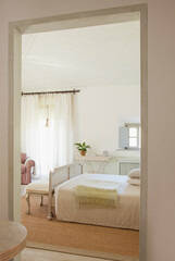 View of luxury bedroom through doorway