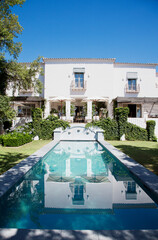 Luxury lap pool and villa - obrazy, fototapety, plakaty