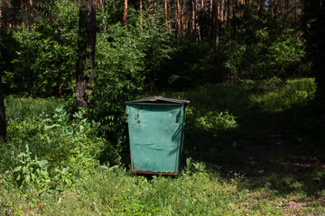 large trash can in the forest